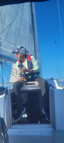 Elaine sitting on the companionway hatch of Foxfire