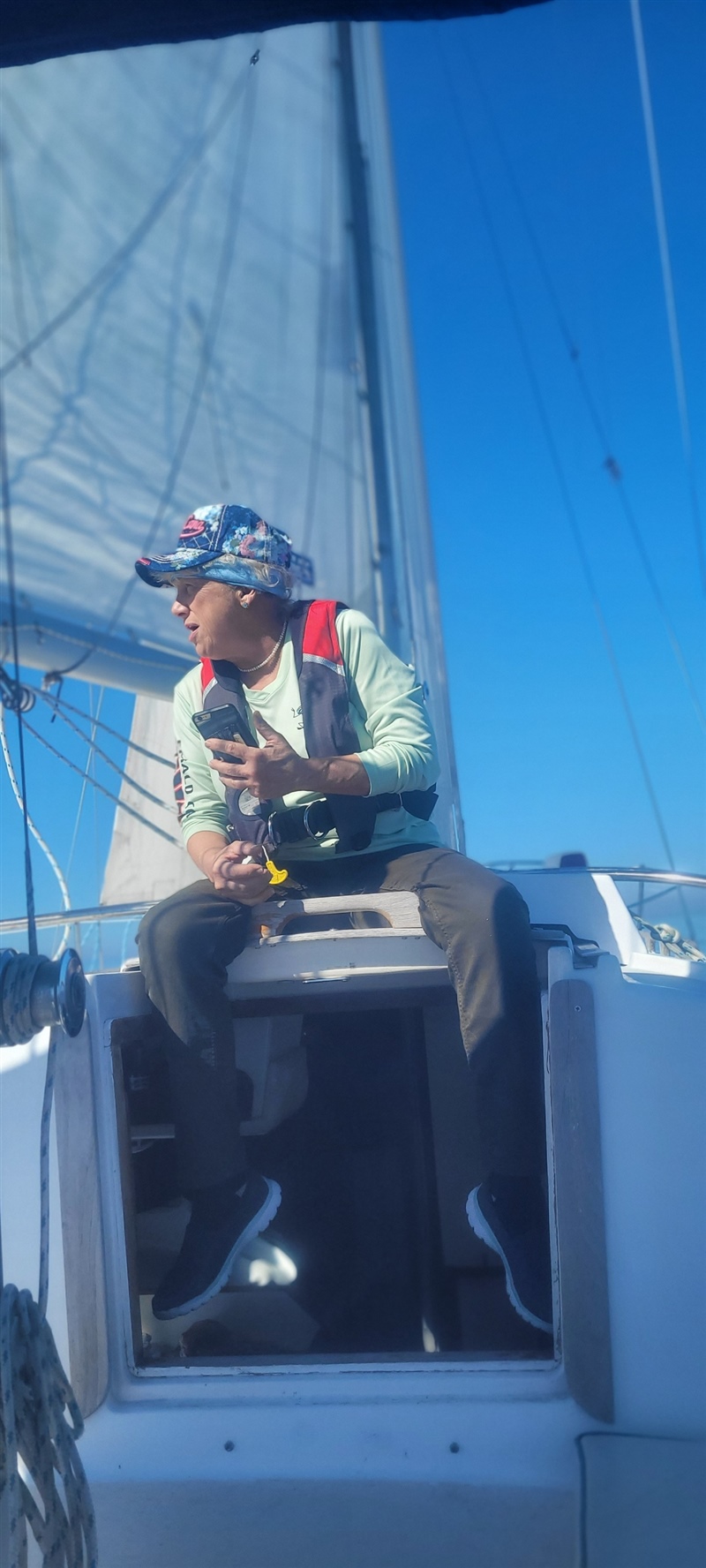 Elaine sitting on the companionway hatch of Foxfire