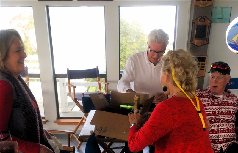 Roberta Bienvenu stealing Julie's Secret Santa gift while hubby John and friend Tom Reynold looks on